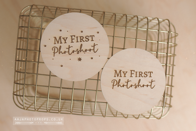 Two wooden posing with 'My First Photoshoot' baby shower prop